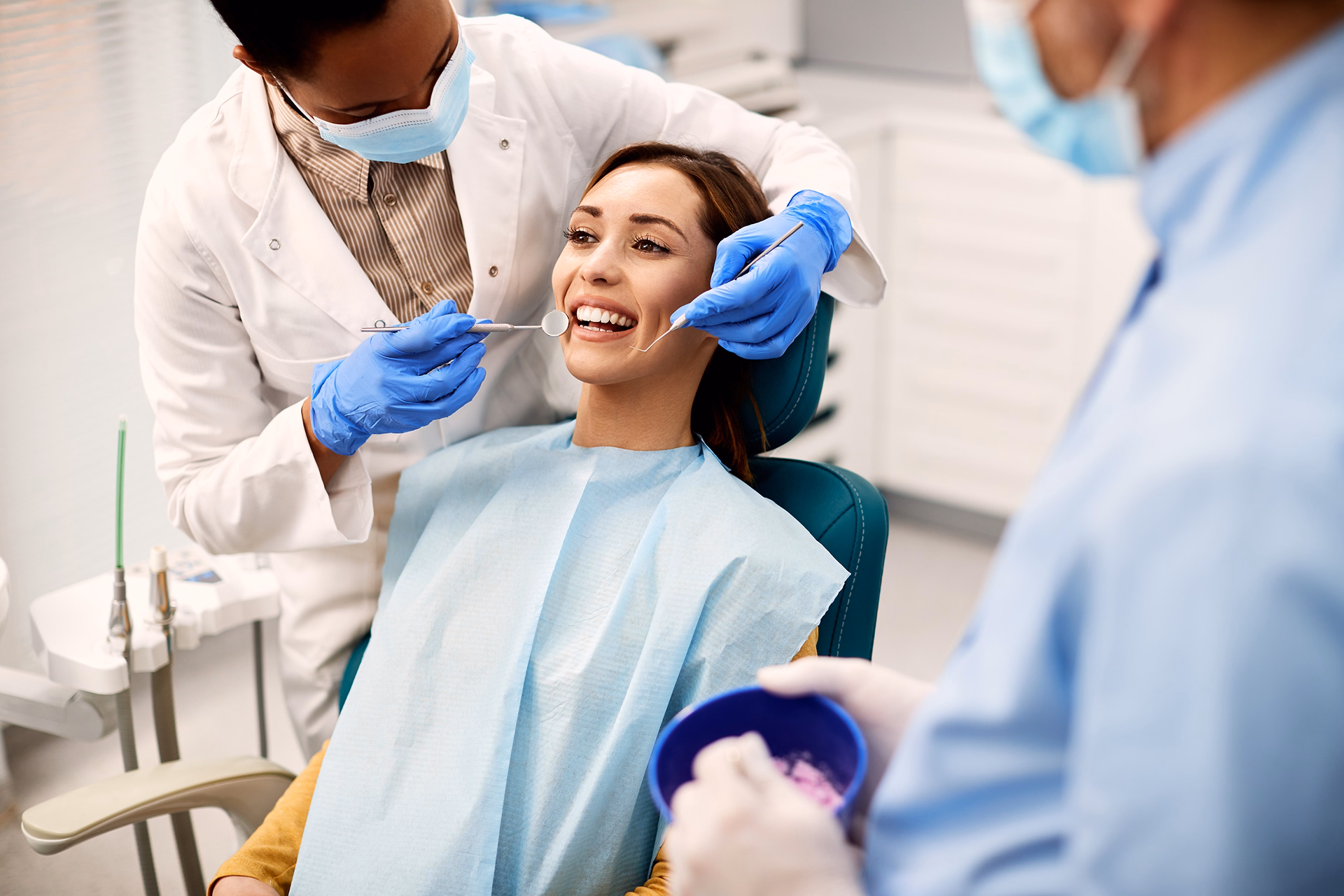happy-woman-getting-her-teeth-examined-by-african-2024-12-13-21-46-30-utc