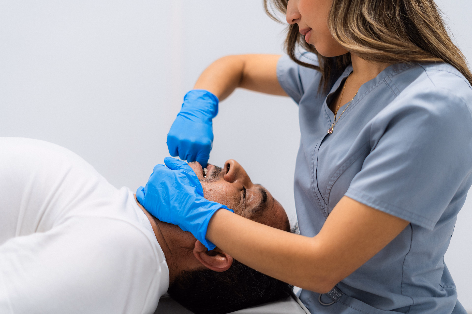 physiotherapist-performing-jaw-physiotherapy-on-pa-2025-05-06-16-27-31-utc